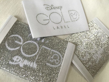 A roupa tecida dobra da extremidade de Bage do ouro de Disney etiqueta o corte frio/corte do calor