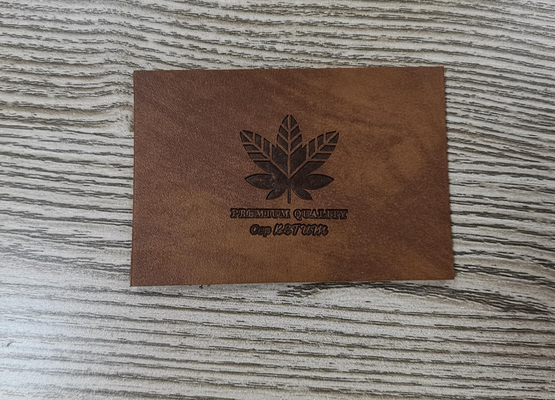Costurar nos remendos que de couro do plutônio da roupa o vestuário etiqueta o logotipo gravado